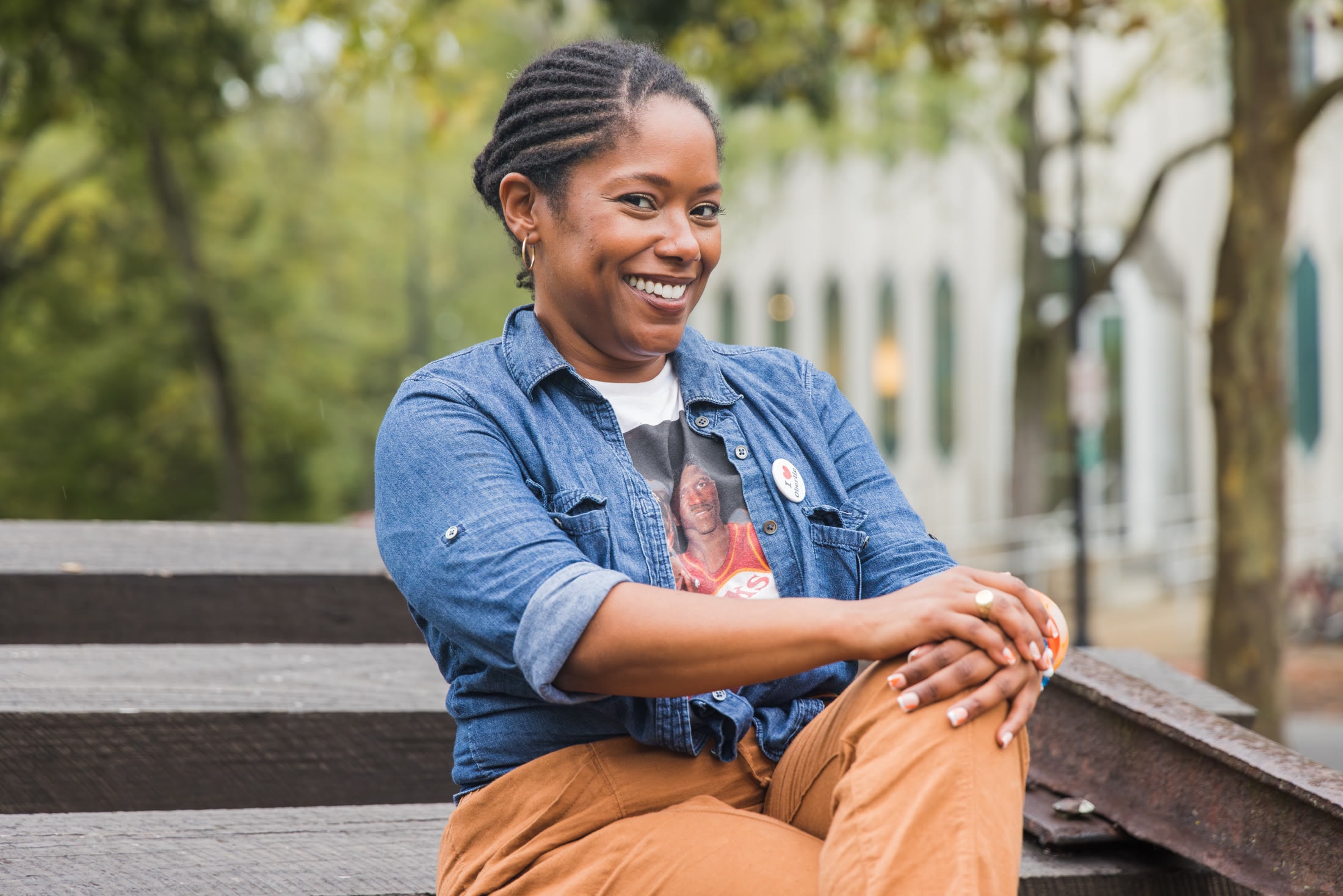 Outdoor portrait of a smiling woman seated on a bench