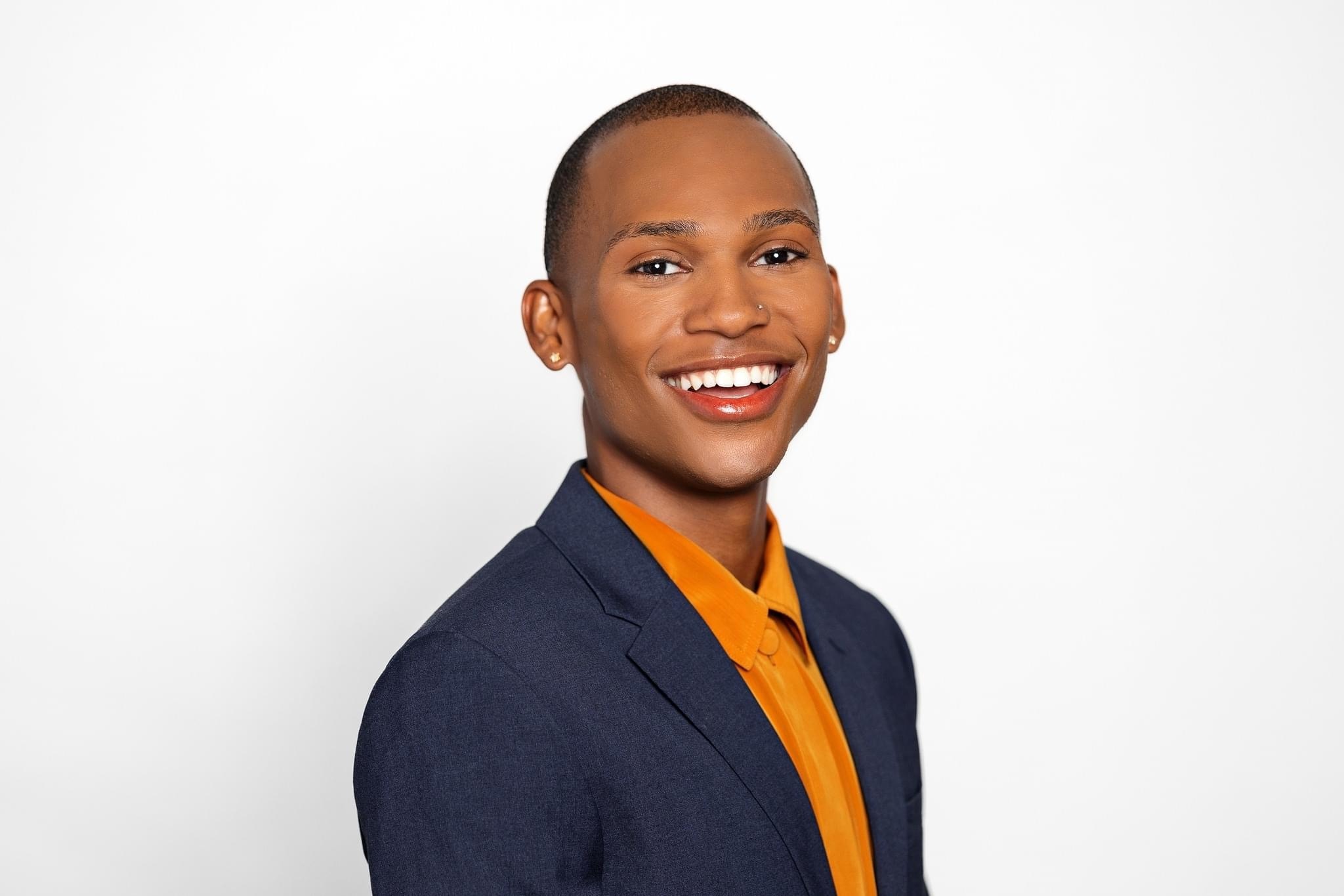 Dae Williams smiling in a studio portrait